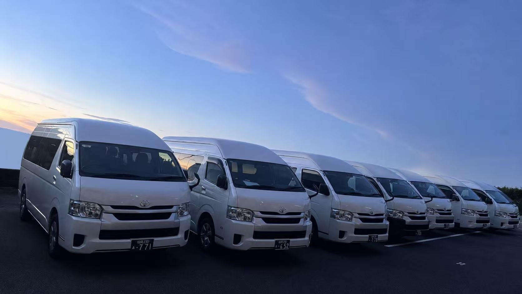 Kyushu Private Drive fleet of white Toyota Hiace vehicles
