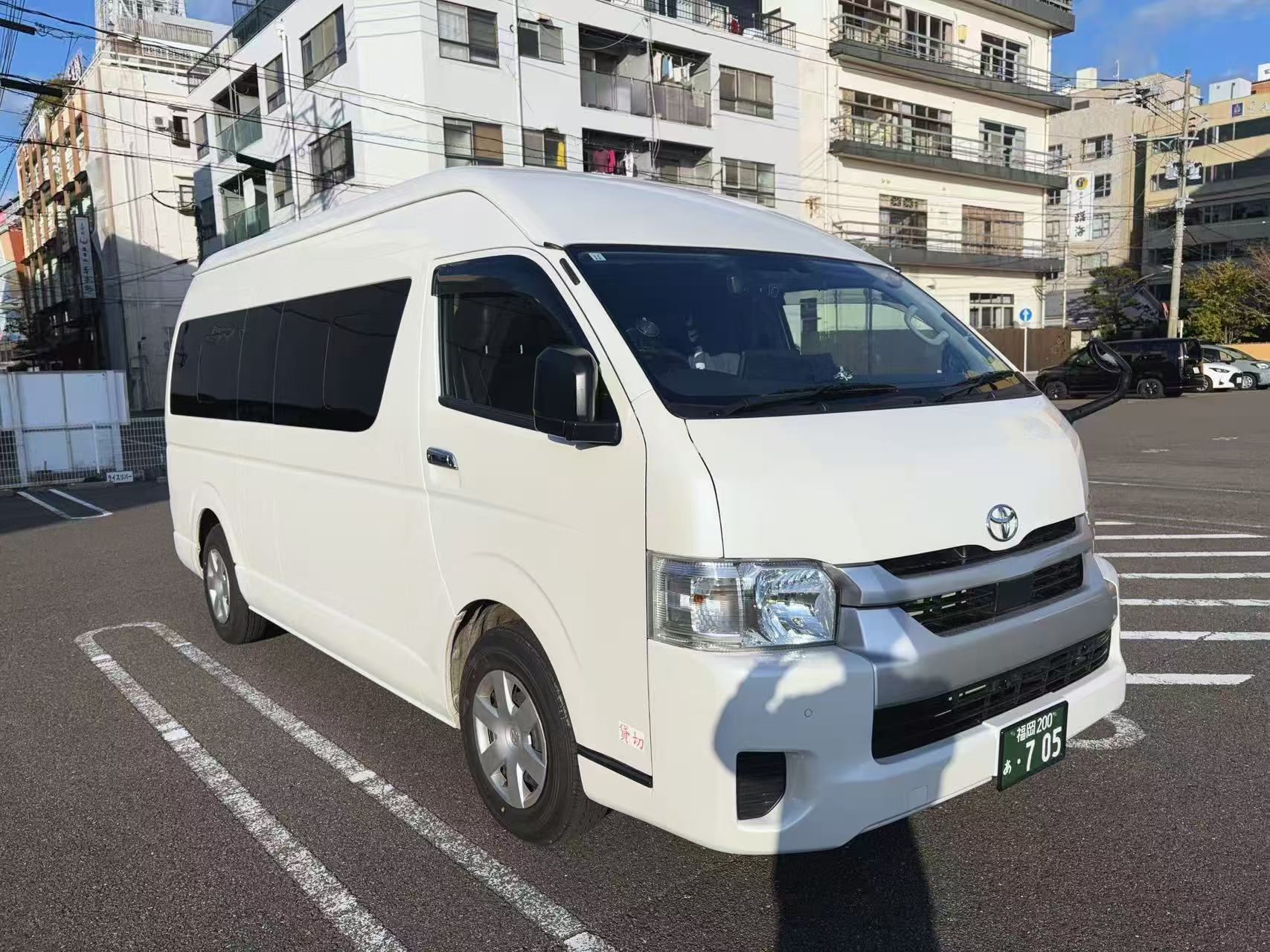 Company-operated white Toyota Hiace number 705